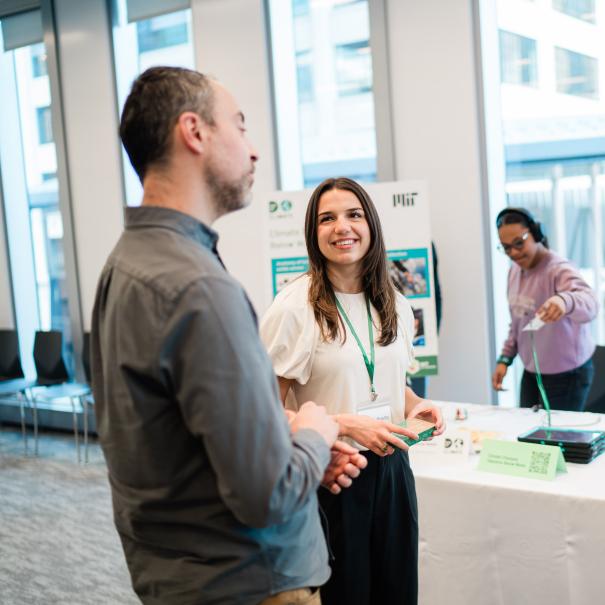 Two attendees at Day of Climate speaking together.