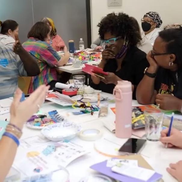A diverse group of adults working together around a table. 